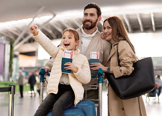 Happy family at airport with passports helped by migration service providers in Kerala